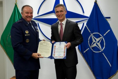 Outgoing SACEUR General Philip Breedlove is presented with NATO Meritorious Service Medal by NATO Secretary General Jens Stoltenberg